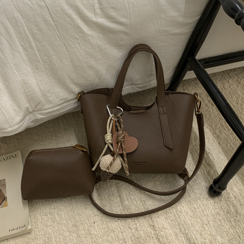 Women's mini handbag in an elegant design with charming pendant