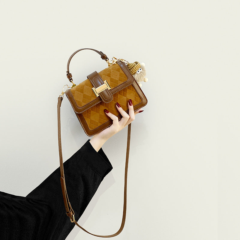 Women’s mini handbag with decorative braided pattern and playful pendant