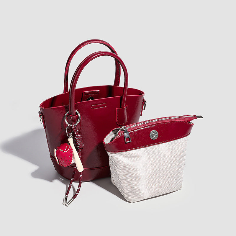 Women's mini bag with shiny surface and playful pendant