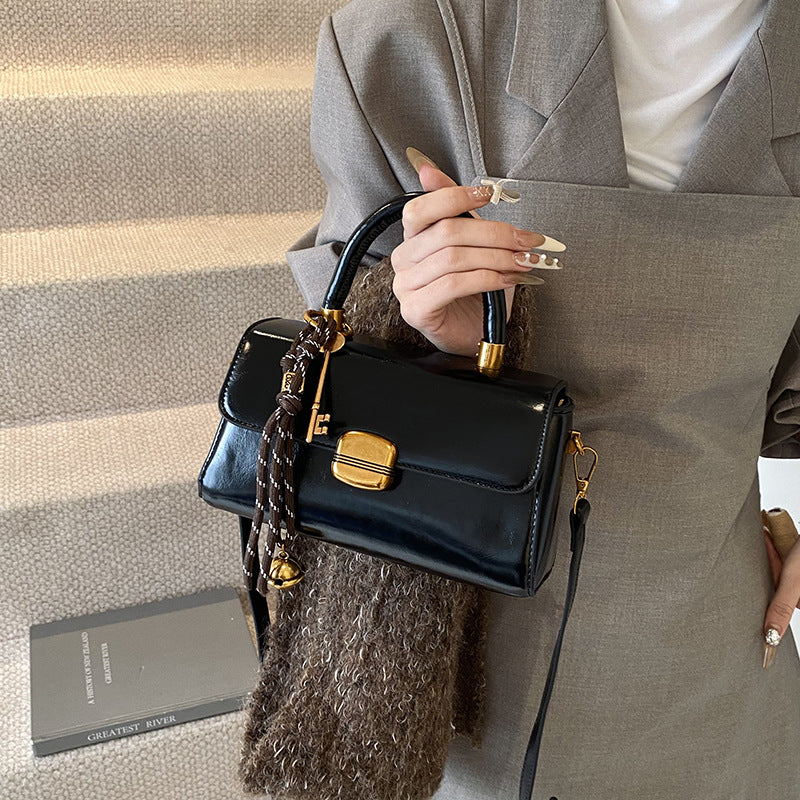 Women's elegant handbag with golden accents