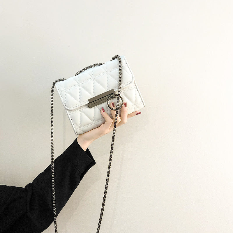 Women's clutch bag with elegant quilting and fine chain strap