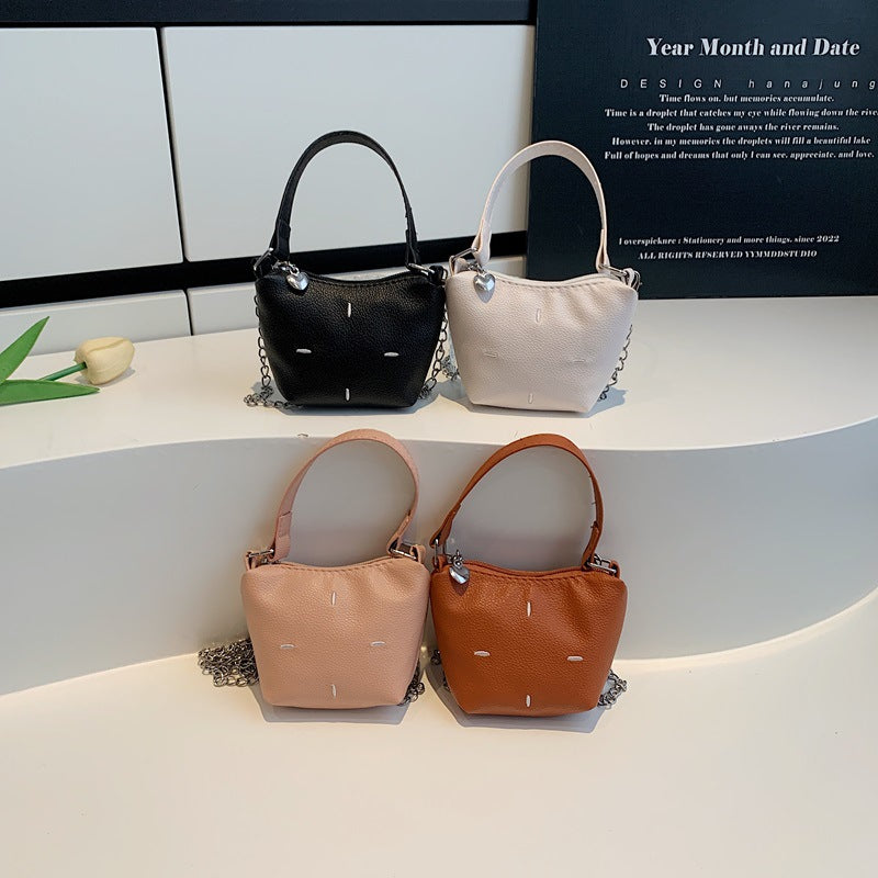 Women's mini handbag with shiny chain and textured upper material