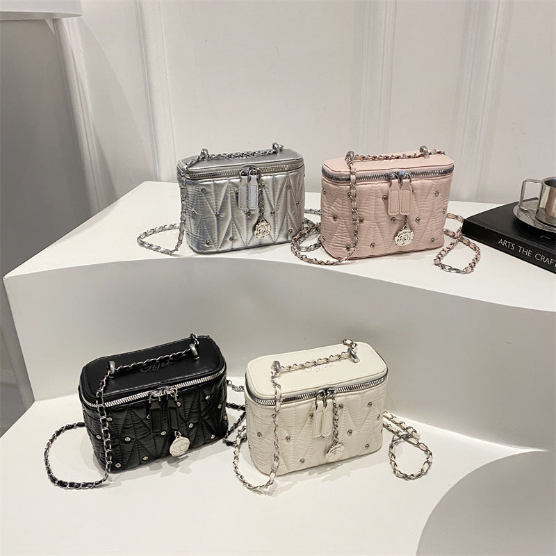 Women's mini handbag with elegant quilting and chain pendant