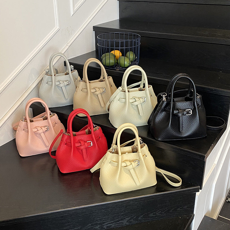 Women's mini handbag with stylish button closure