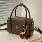 Women's mini handbag with elegant structure and charming pendant