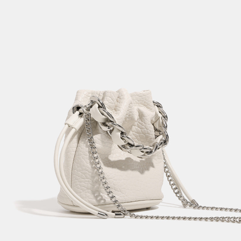 Women's mini backpack bag with elegant chain handle and fine texture