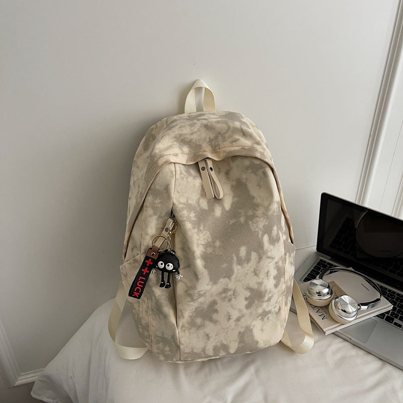 Fashionable backpack with practical design and decorative pendant