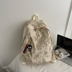 Fashionable backpack with practical design and decorative pendant