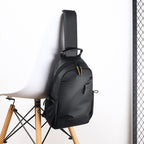 Sling backpack with flexible compartment layout and water-repellent material