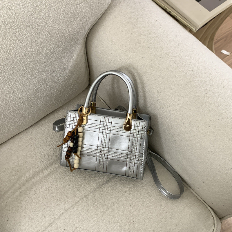 Women's mini handbag with elegant structure and golden accents