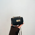 Women’s mini handbag with quilted design and golden clasp