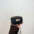 Women’s mini handbag with quilted design and golden clasp