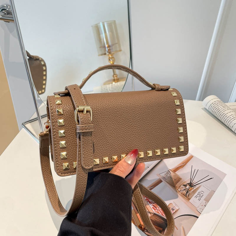 Women's mini handbag with sparkling upper material and golden studs