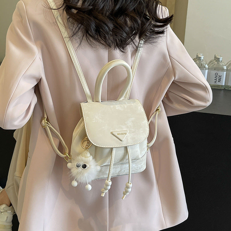 Women's mini backpack with playful design and plush pendant