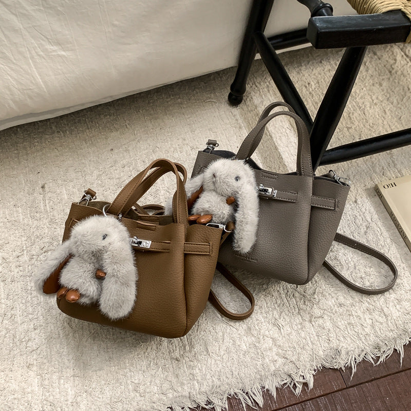 Women's mini handbag with playful design and animal charm