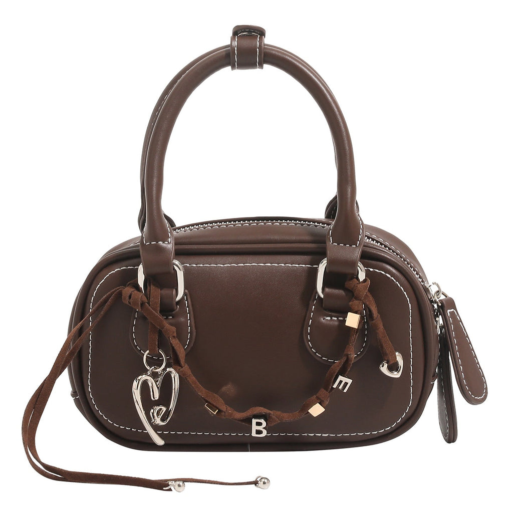 Women's mini handbag with playful drawstring and elegant accents