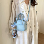 Women's mini handbag with playful animal charm
