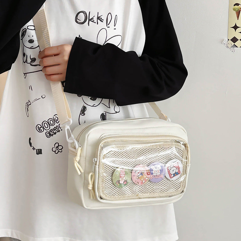 Shoulder bag with transparent viewing pocket and playful graphic design