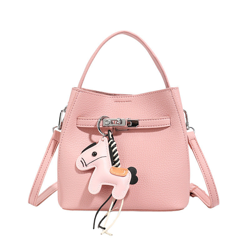 Women’s mini crossbody bag with playful design and cute charm