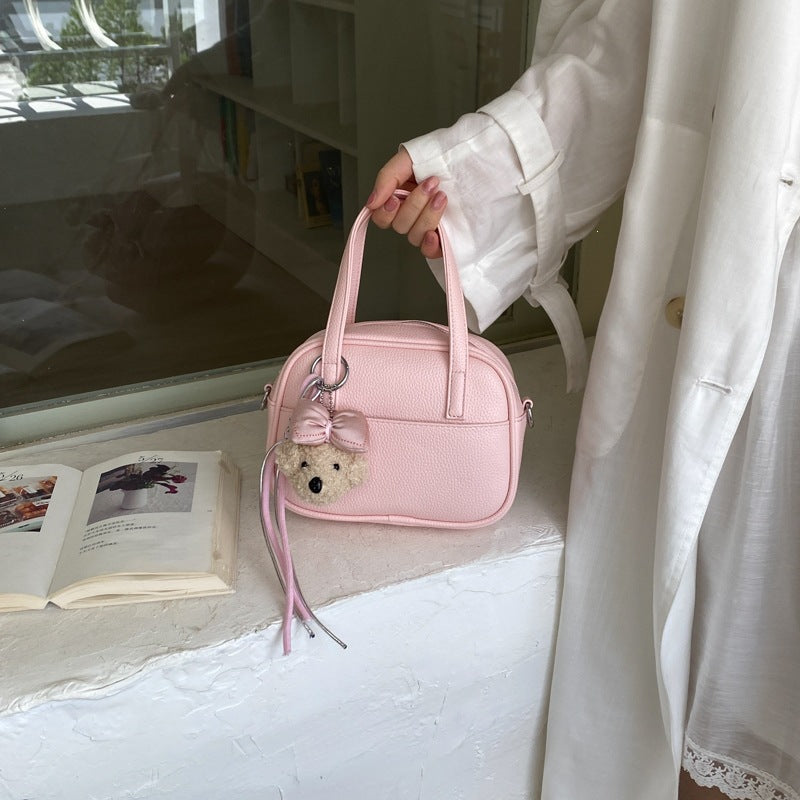 Women's mini handbag with playful animal charm