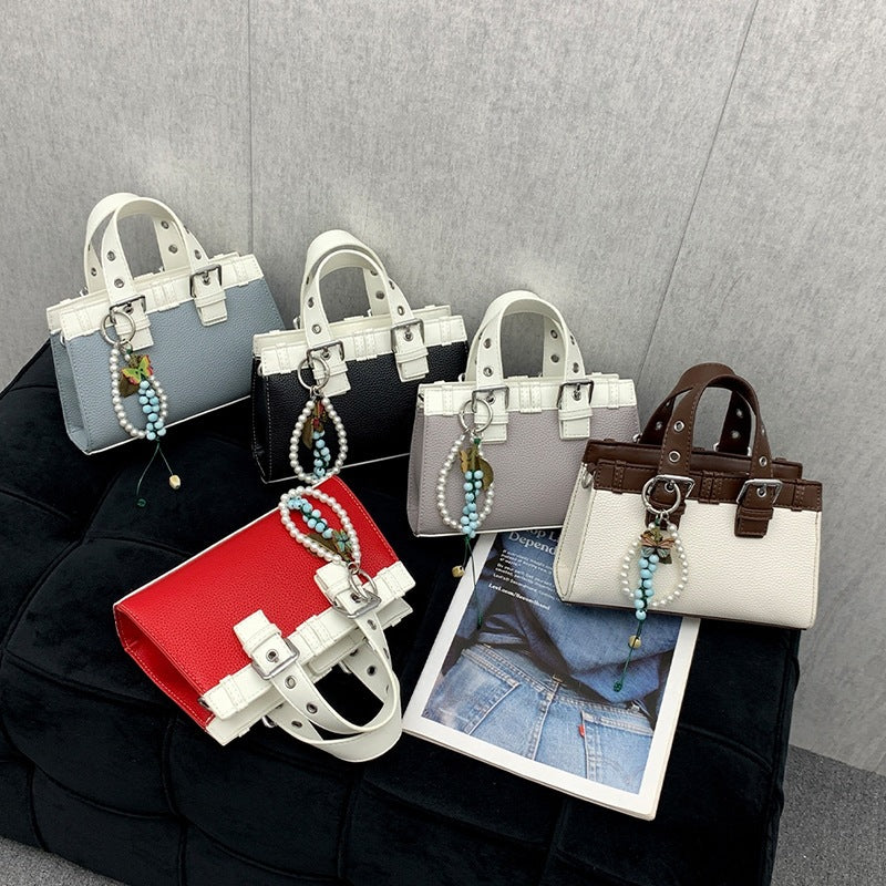 Women's mini handbag with playful pendant and elegant design