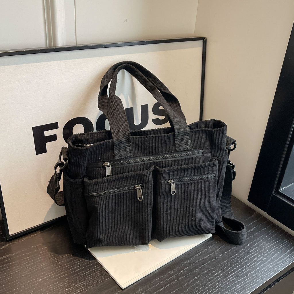 Durable shoulder bag with multiple compartments