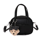 Women's mini handbag with playful animal charm