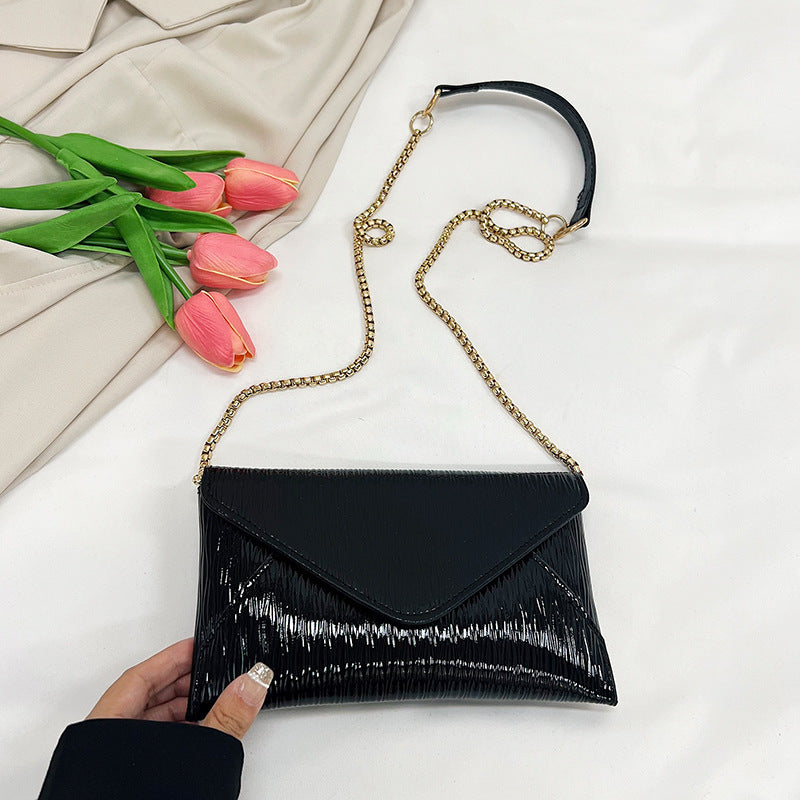 Women's elegant clutch with shiny upper material
