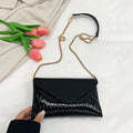 Women's elegant clutch with shiny upper material