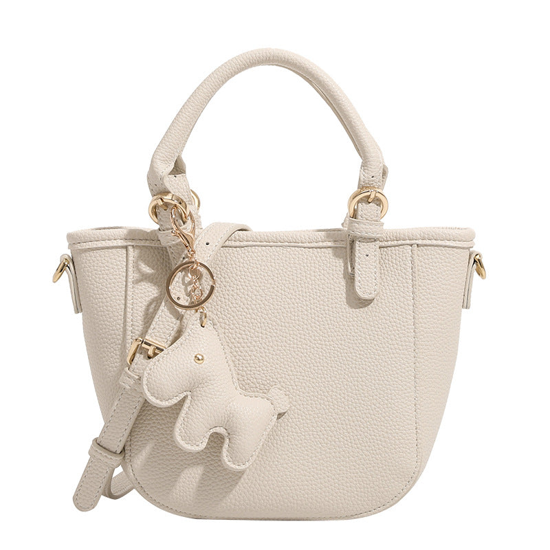 Women's mini handbag with playful animal charm