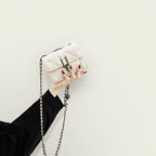 Women’s mini clutch with elegant chain strap and luxurious quilted pattern