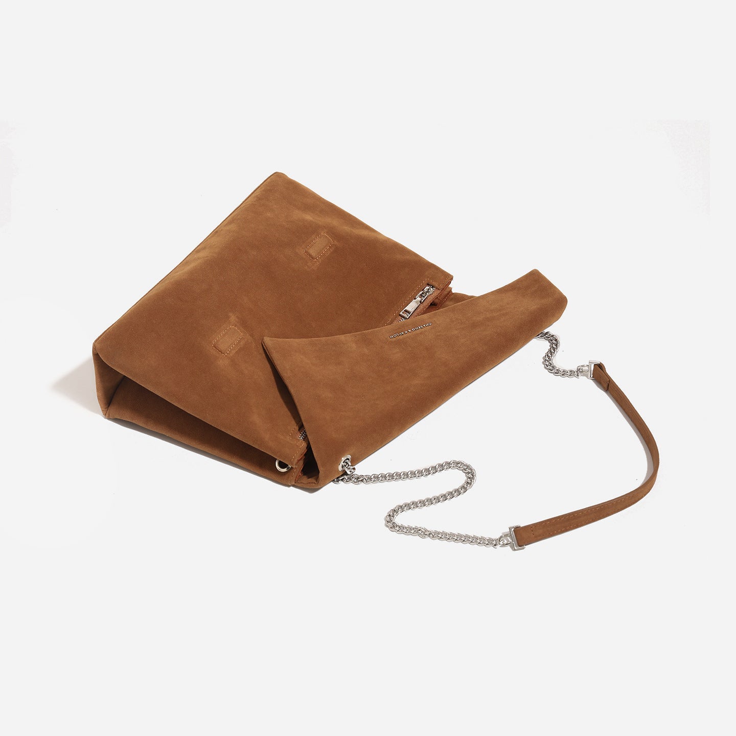 Women's clutch bag made of shiny synthetic leather with decorative chain strap