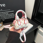 Ladies mini handbag with luxurious accents and adjustable shoulder strap