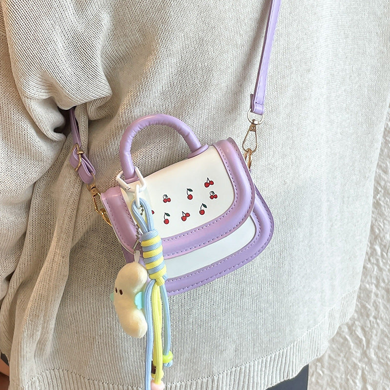 Women's mini handbag with cheerful cherry design and charming pendants
