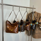 Shoulder bag with charming applications