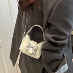 Women’s mini handbag with stylish bow closure