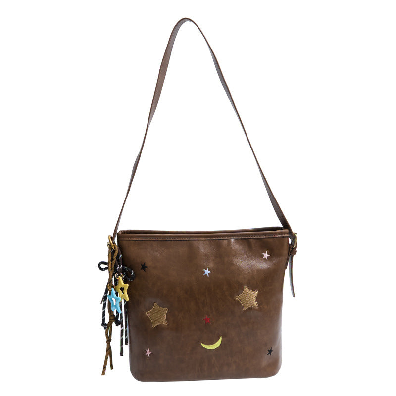 Shoulder bag with charming applications
