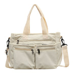 Durable shoulder bag with multiple compartments