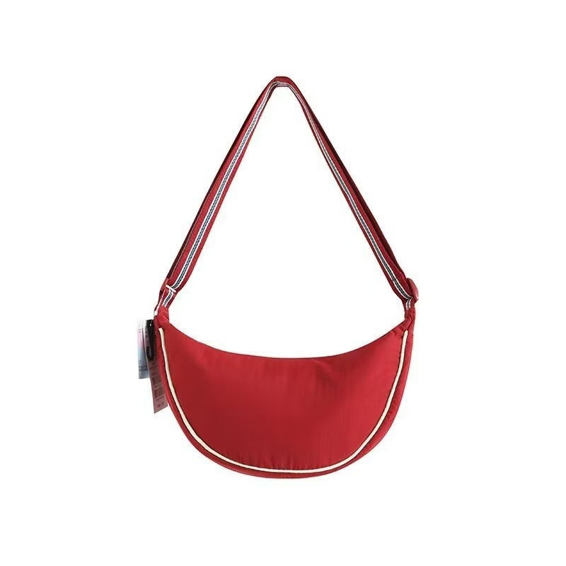 Shoulder bag with adjustable shoulder strap and versatile interior compartment