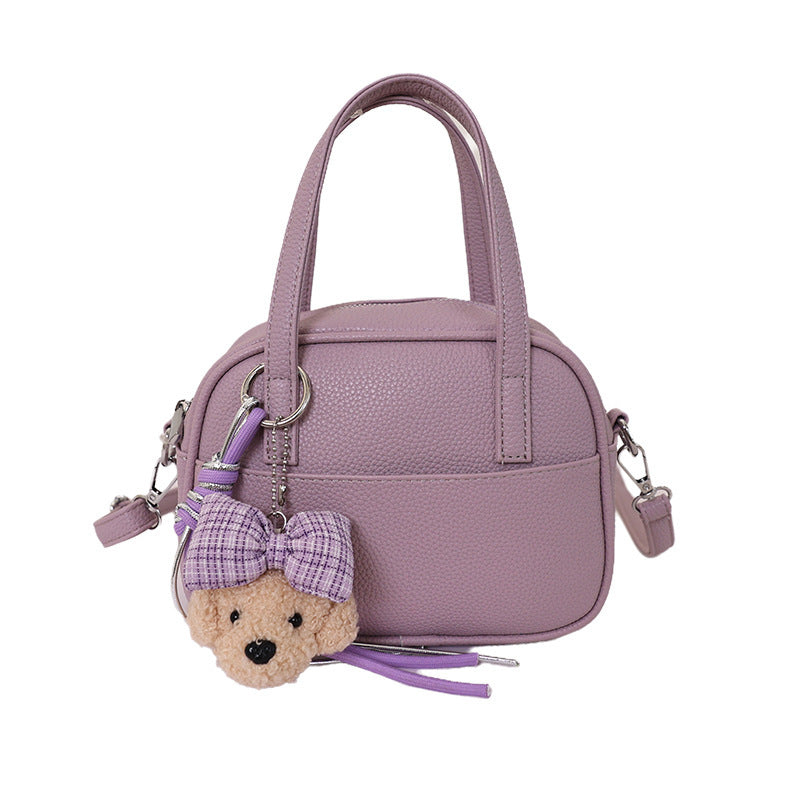 Women's mini handbag with playful animal charm