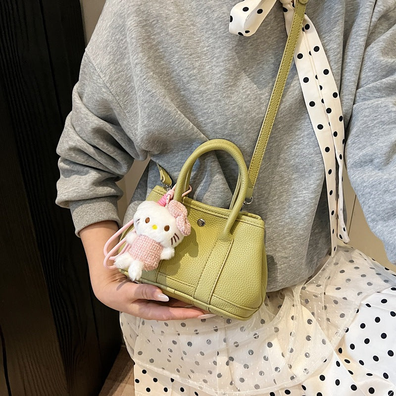 Women’s mini handbag with playful plush pendant