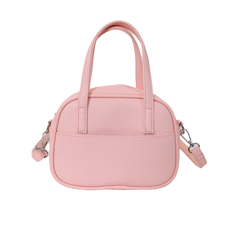 Women's mini handbag with playful animal charm