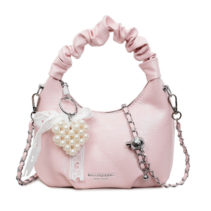 Ladies mini handbag with voluminous ruffle design and trendy charms