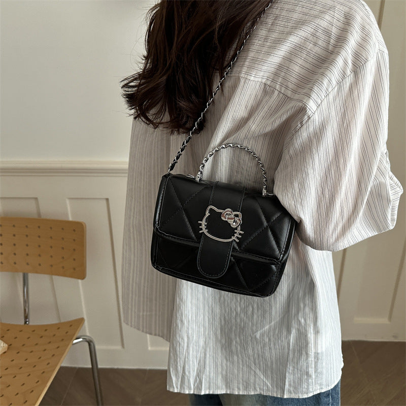Ladies mini handbag with decorative quilting and playful cat motif