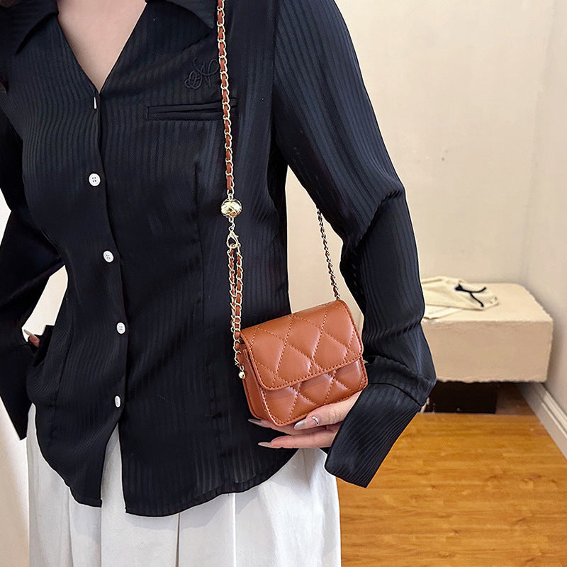 Ladies mini crossbody bag with shiny chain and charming pendant