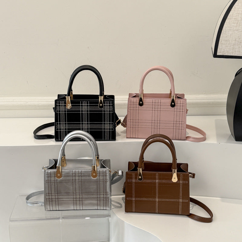 Women's mini handbag with elegant structure and golden accents
