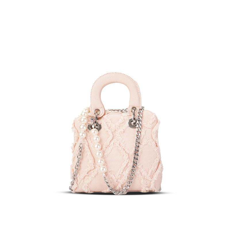 Women’s mini handbag with striking cinched design and pearl accents