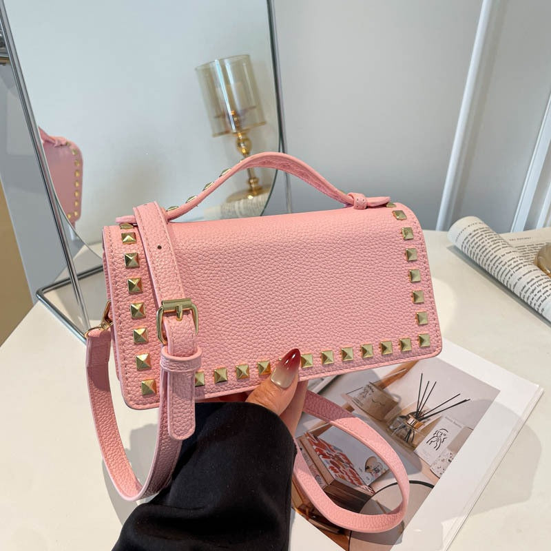 Women's mini handbag with sparkling upper material and golden studs