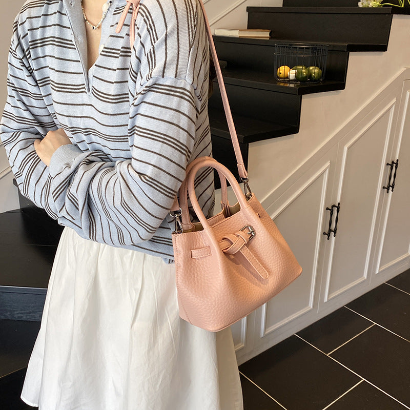 Women's mini handbag with stylish button closure