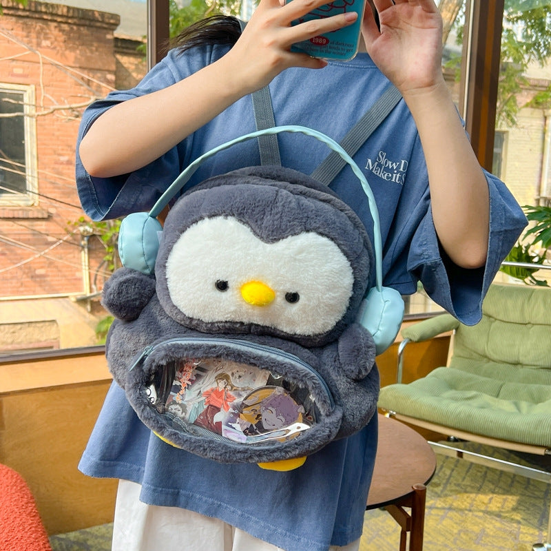 Plush backpack with transparent viewing window